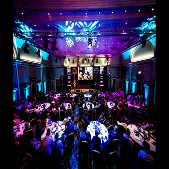 Corporate gala event with stage lighting, projection screens, and AV rentals for immersive visual experience